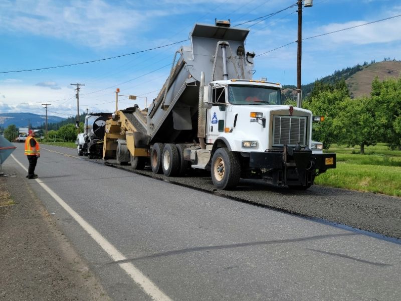 Construction equipment performing full-depth recycling during a roadway rehabilitation project to rebuild deteriorated pavement.